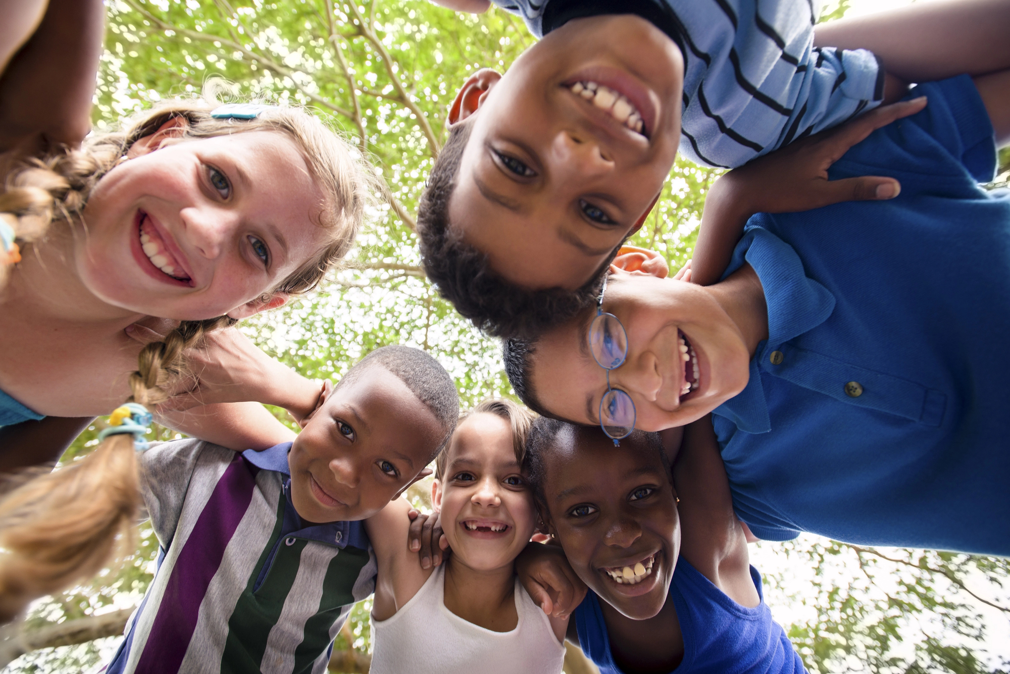 Children playing together outdoors, smiling and connected